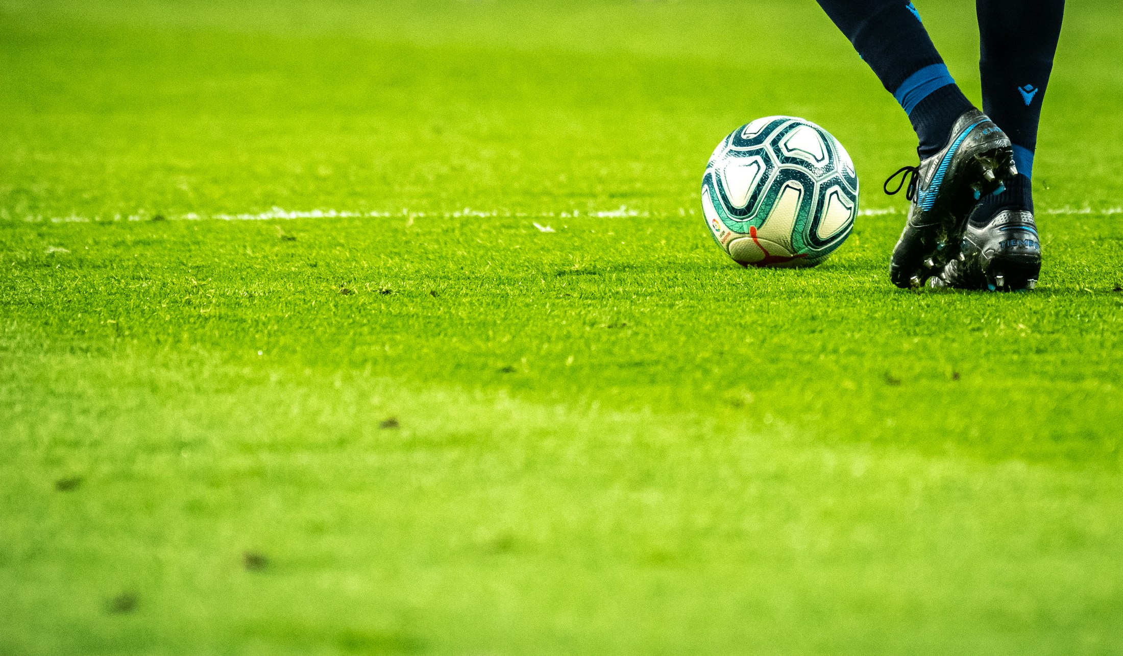 A soccer match underway on a green pitch